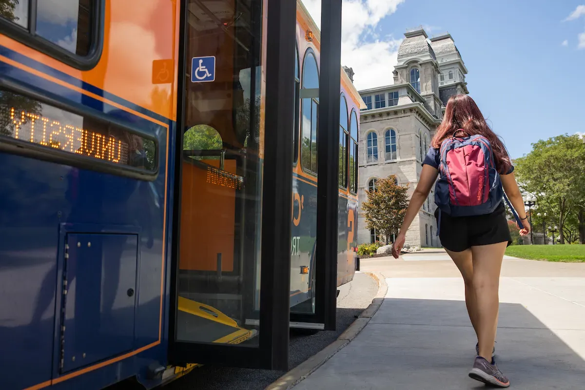 Student getting off bus outside of the Hall of Languages building.